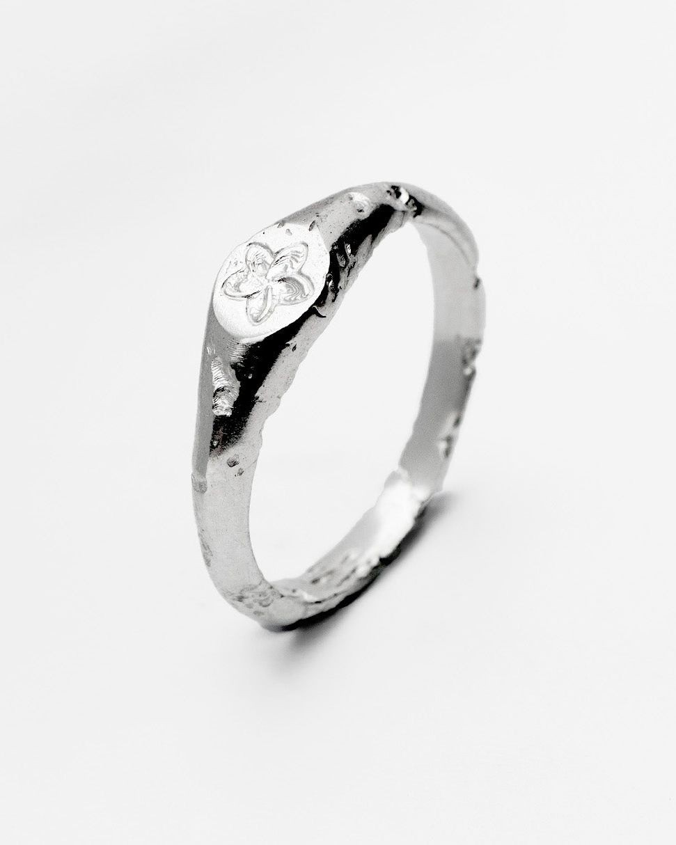 Plumeria ring in sterling silver — angled view of the frangipani motif and organic band